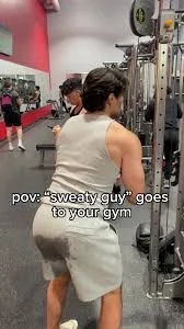 A gym-goer in grey shorts with a sweat stain, captioned “pov: sweaty guy goes to your gym.”